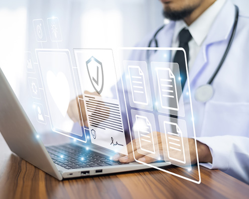 image of a doctor wearing a white lab coat, black stethescope, and black tie standing infront of a laptop computer with various, white, icons floating infront of them